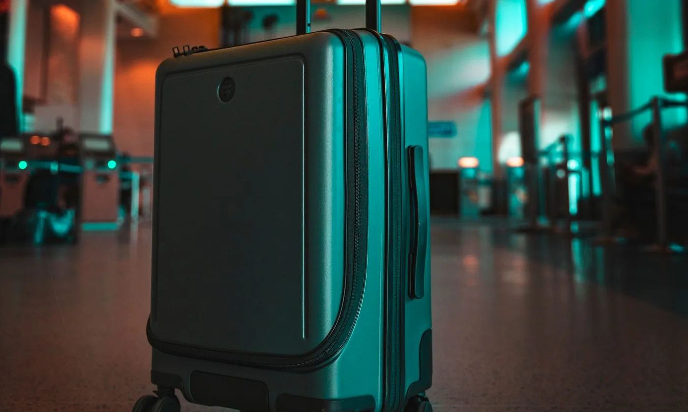 Rolling suitcase in a brightly lit airport terminal in Los Angeles