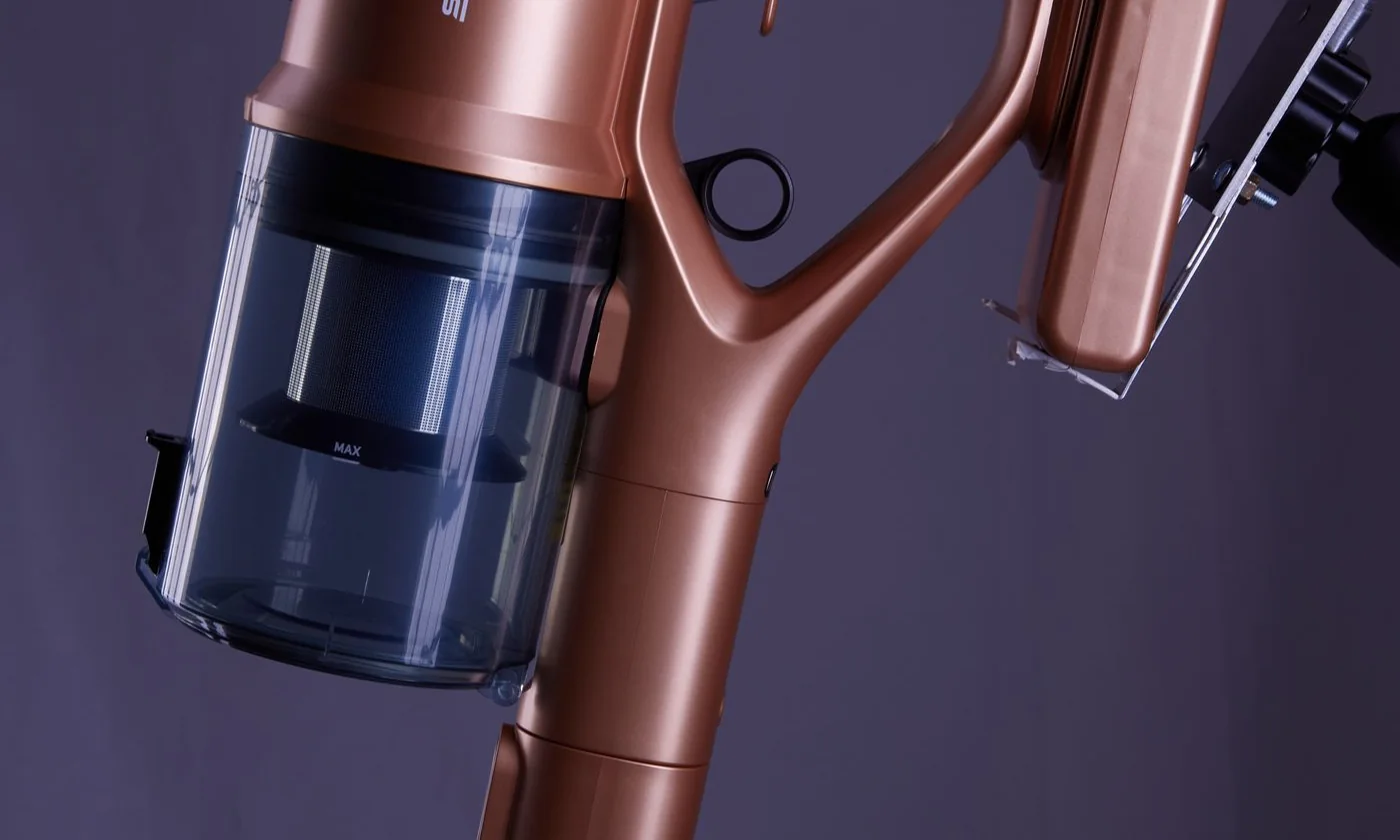 Close-up of the handle and dust container on a cordless vacuum