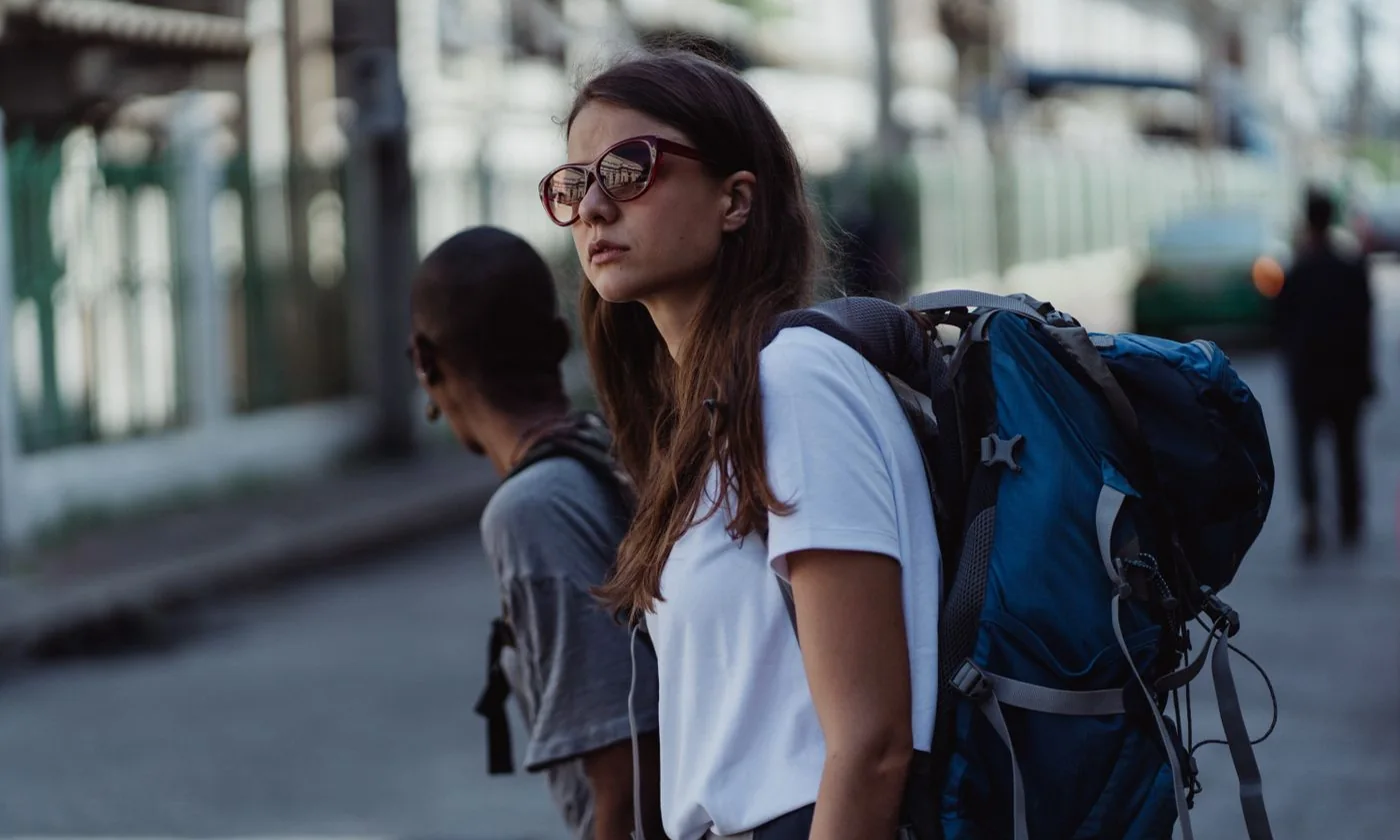 Woman carrying a backpack on a city street