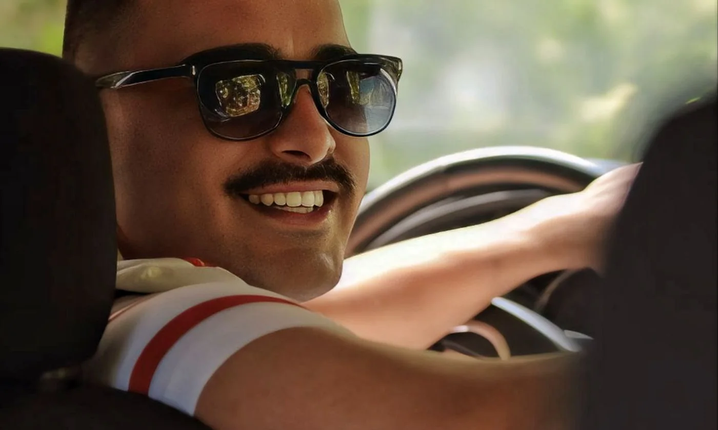 Driver wearing sunglasses while seated inside a car
